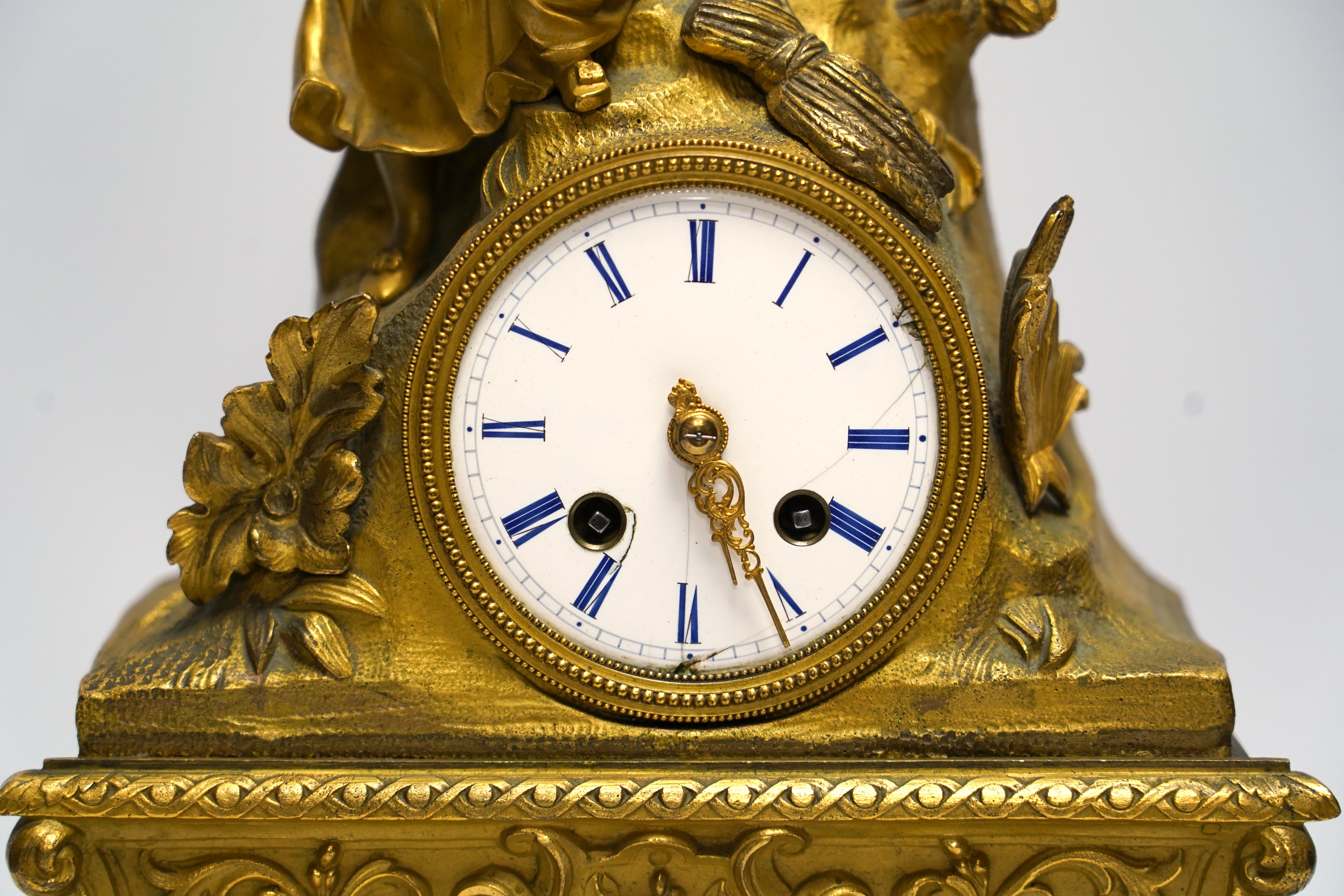 A mid 19th century French ormolu figural mounted clock with silk suspension, with key, 36cm